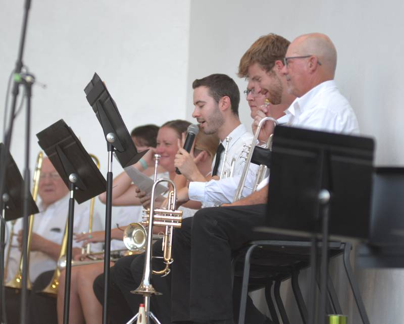 Oregon High School music teacher Zach Hall speaks to the crowd before performing with the Kable Concert Band on Wednesday, July 23, 2025 in Mt. Morris.