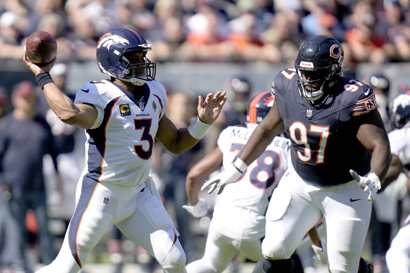 Denver Broncos quarterback Russell Wilson passes as Chicago Bears defensive tackle Andrew Billings defends during the first half, Sunday, Oct. 1, 2023, in Chicago.