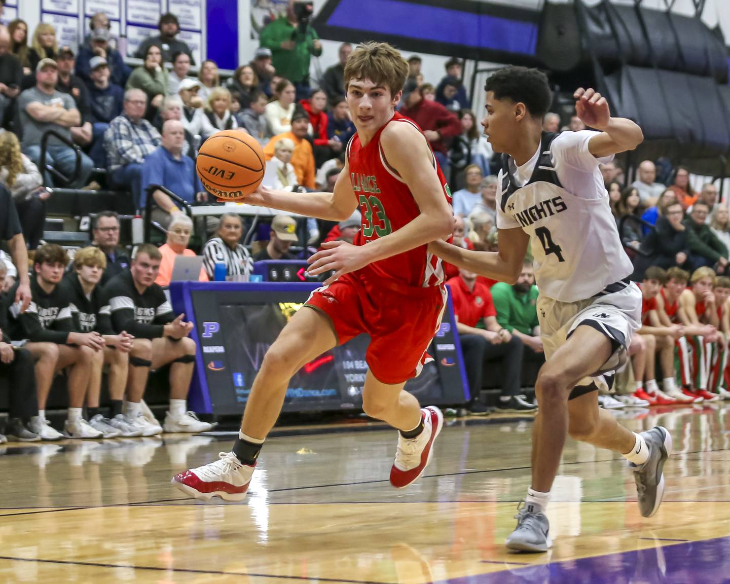 LaSalle Peru's Gavin Stokes (33) drives past the defense of Kaneland's Brian Edwards (4) during their Plano Christmas Classic semi-final basketball game between Kaneland at LaSalle Peru Monday, Dec 29, 2025 in Plano.