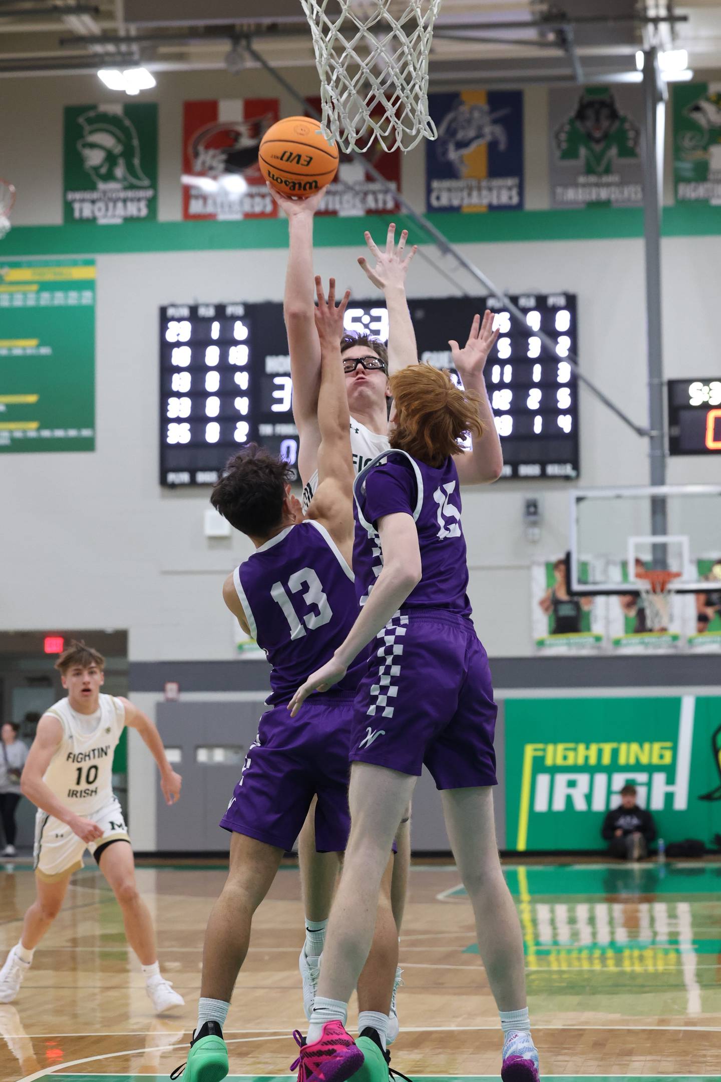 Bishop McNamara's Callaghan O'Connor puts up a shot under pressure from Wilmington's Hunter Kaitschuck (13) and Tyler Krand during Bishop McNamara's 61-24 victory over Wilmington in the IHSA Class 2A Seneca Sectional semifinal on Tuesday, March 3, 2026.