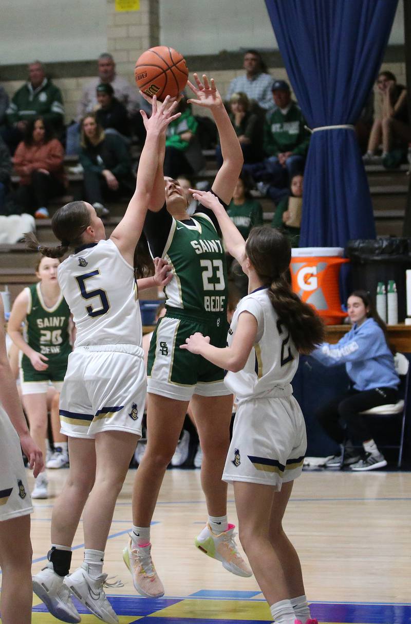 St. Bede's Ali Bosnich pulls up in the lane to shoot a shot over Marquette's Chloe Larson and teammate Anna Hjerpe on Monday, Nov. 27, 2023 in Bader Gym at Marquette High School.