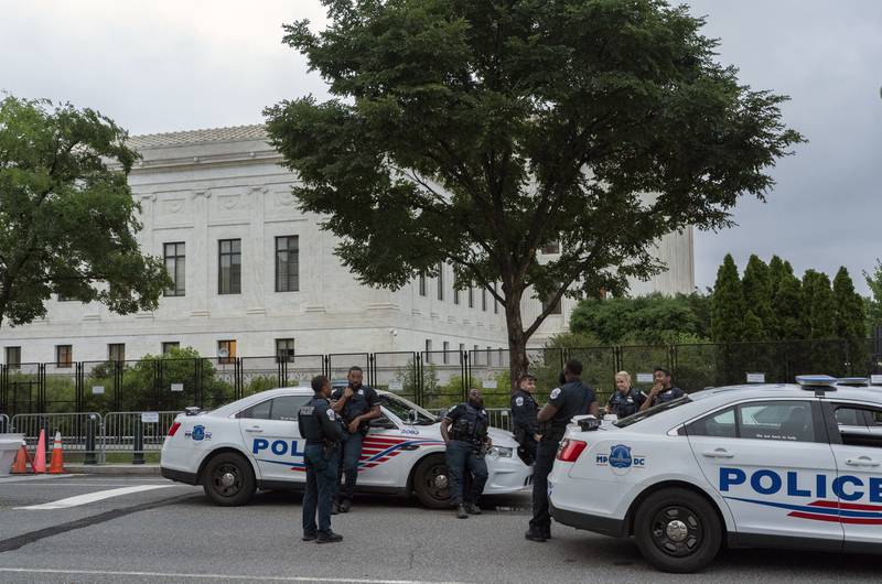 Police officers stand outside U.S. Supreme Court in Washington, Thursday, June 23, 2022. (AP Photo/Gemunu Amarasinghe)