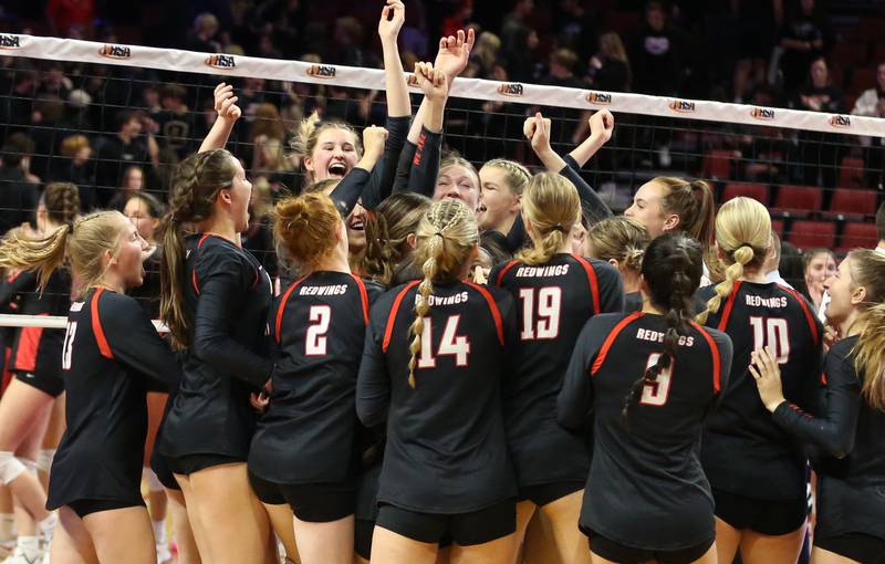 Members of the Benet Academy volleyball react after defeating Barrington in the Class 4A semifinal game on Friday, Nov. 11, 2022 at Redbird Arena in Normal.