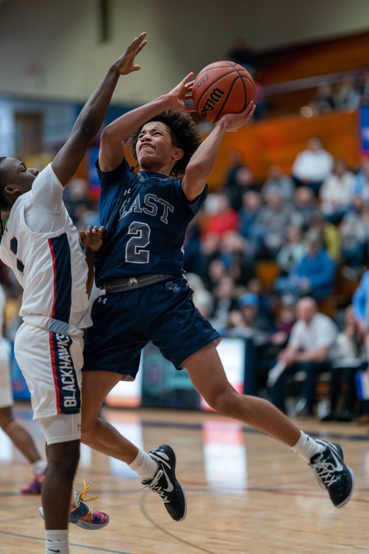 Oswego East's Bryce Shoto (2) shoots the ball against West Aurora's Denta'e Woods (1) during a basketball game at West Aurora High School on Friday, Jan 27, 2023.