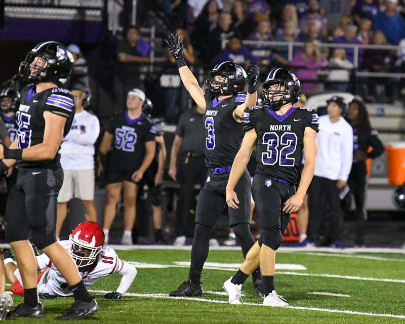 Downers Grove North's Jonahon Nelson (3) celebrates as teammate Baker Glomb (32) watches the kick go through the up rights to put three points on the board during the game on Friday Sept. 12, 2025, while taking on Hinsdale Central held at Downers Grove North High School.