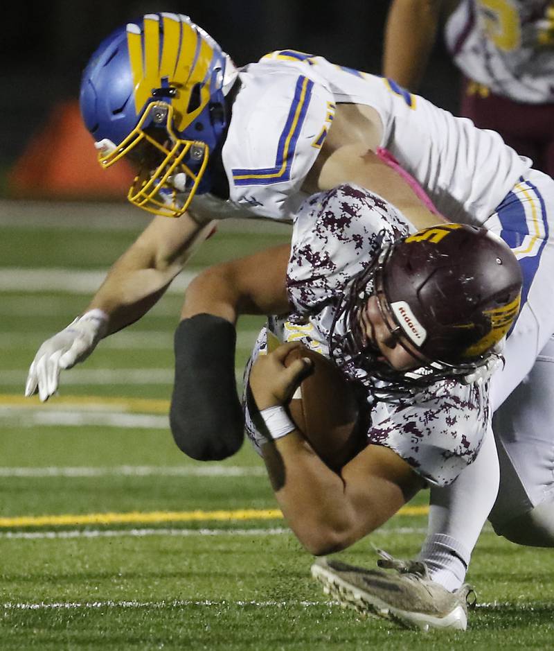 Richmond-Burton's Braxtin Nellessen dives for extra yards as he is tackled by Johnsburg's Blake Hiller during a Kishwaukee River Conference football game Friday, Oct. 7, 2022, between Richmond-Burton and Johnsburg at Richmond-Burton Community High School in Richmond.