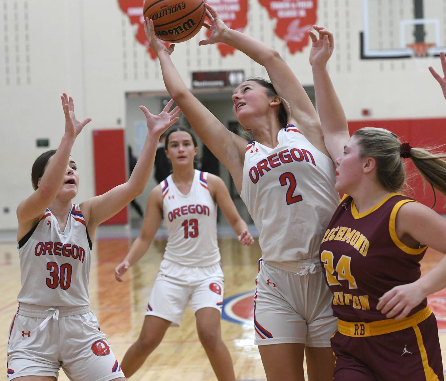 Oregon's Ava Hackman (2) stretches for a rebound against Richmond Burton at the Oregon Tip Off Tournament on Wednesday. Nov. 26. Also pictured for Oregon are Mya Engekes (30) and Sarah Eckardt (13).