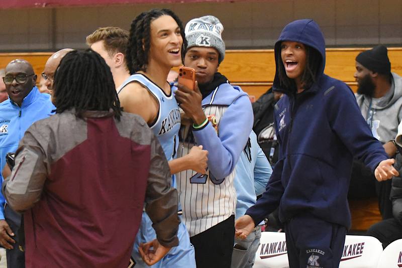 Kankakee's Lincoln Williams, second from left, smiles as he looks to the scoreboard to see his single-game school record 44 points in the Kays' home game against Thornridge Friday, Dec. 5, 2025.
