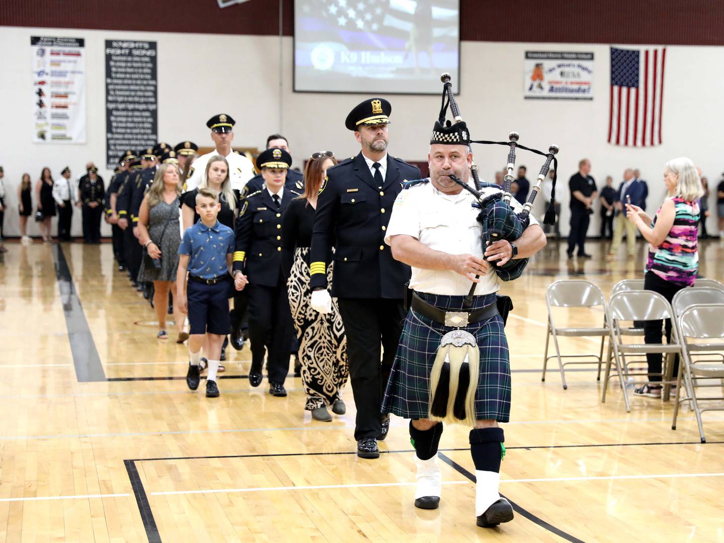 Kane County Sheriff Ron Hain (second from right) and Kane County Sheriff personnel are led by a bagpiper during a funeral in honor of Kane County Sheriff K9 Hudson, who lost his life in the line of duty last month, on Thursday, June 1, 2023 at Kaneland Harter Middle School in Sugar Grove.