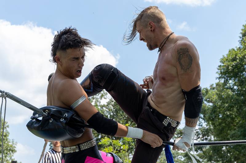 (left to right) Jordan Kross is delivered a high knee by Matt Hatter at the Taste of the Illinois Valley DreamWave Wrestling event on Saturday, August 2, 2025 at Centennial Park in Peru.