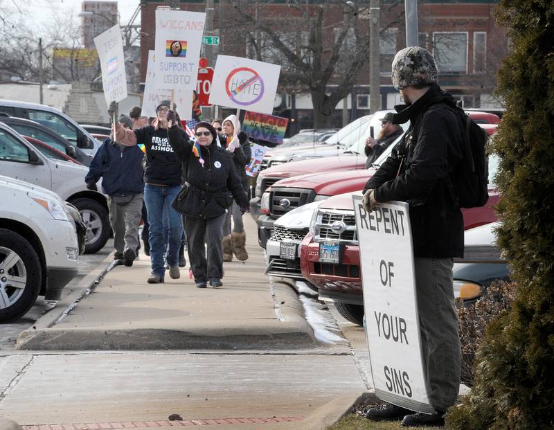 LGBTQ supporters approach a drag show protester in front of the Sandwich Opera House on Saturday, Feb. 18, 2023.