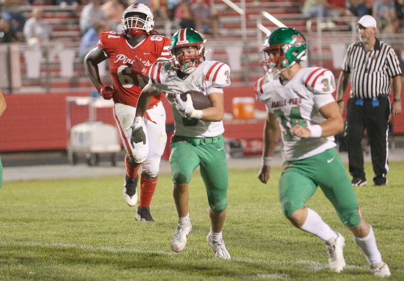 L-P's Rylynd Rynkewicz runs with the ball down the field as Ottawa's Stephon Patrick chases him down on Friday, Sept. 12, 2025 at King Field.