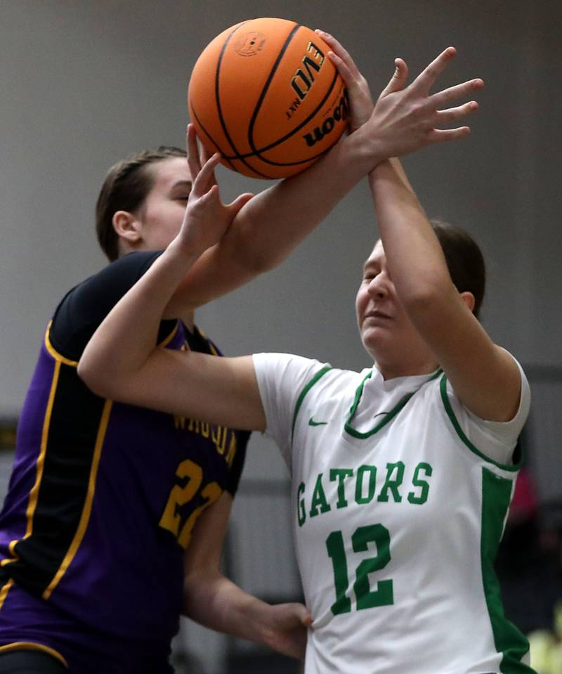 Crystal Lake South's Gaby Dzik tries to take a shot as she is hit by Wauconda's Kelsey Piehl during the Northern Illinois Holiday Classic Championship girl basketball game on Thursday, Dec. 18, 2025, at McHenry High School.