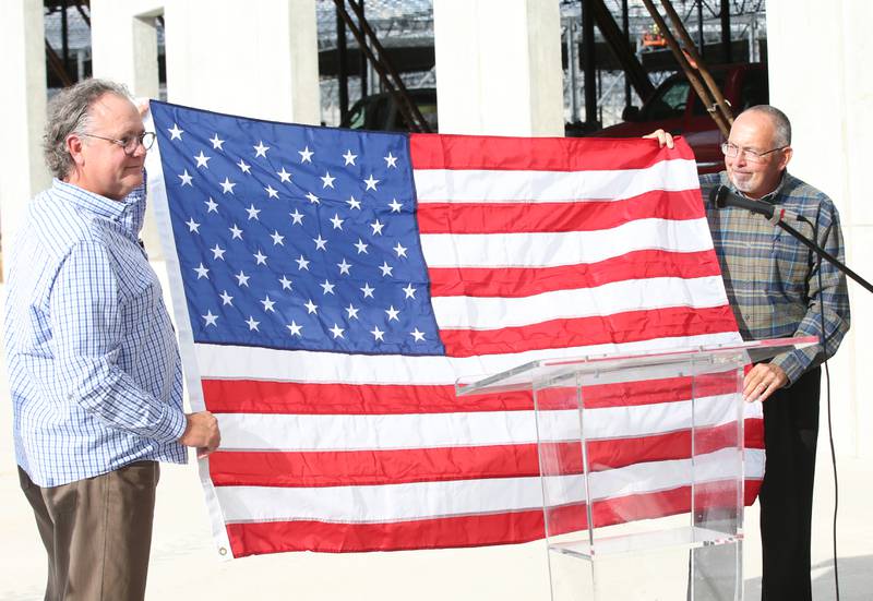 Princeton mayor Ray Mabry presents Ollies Bargain Outlet CEOJohn Swyherg with an American Flag to fly at the new new distribution center d during a construction milestone at the new Ollie's distribution center on Tuesday, Sept. 26, 2023 in Princeton.