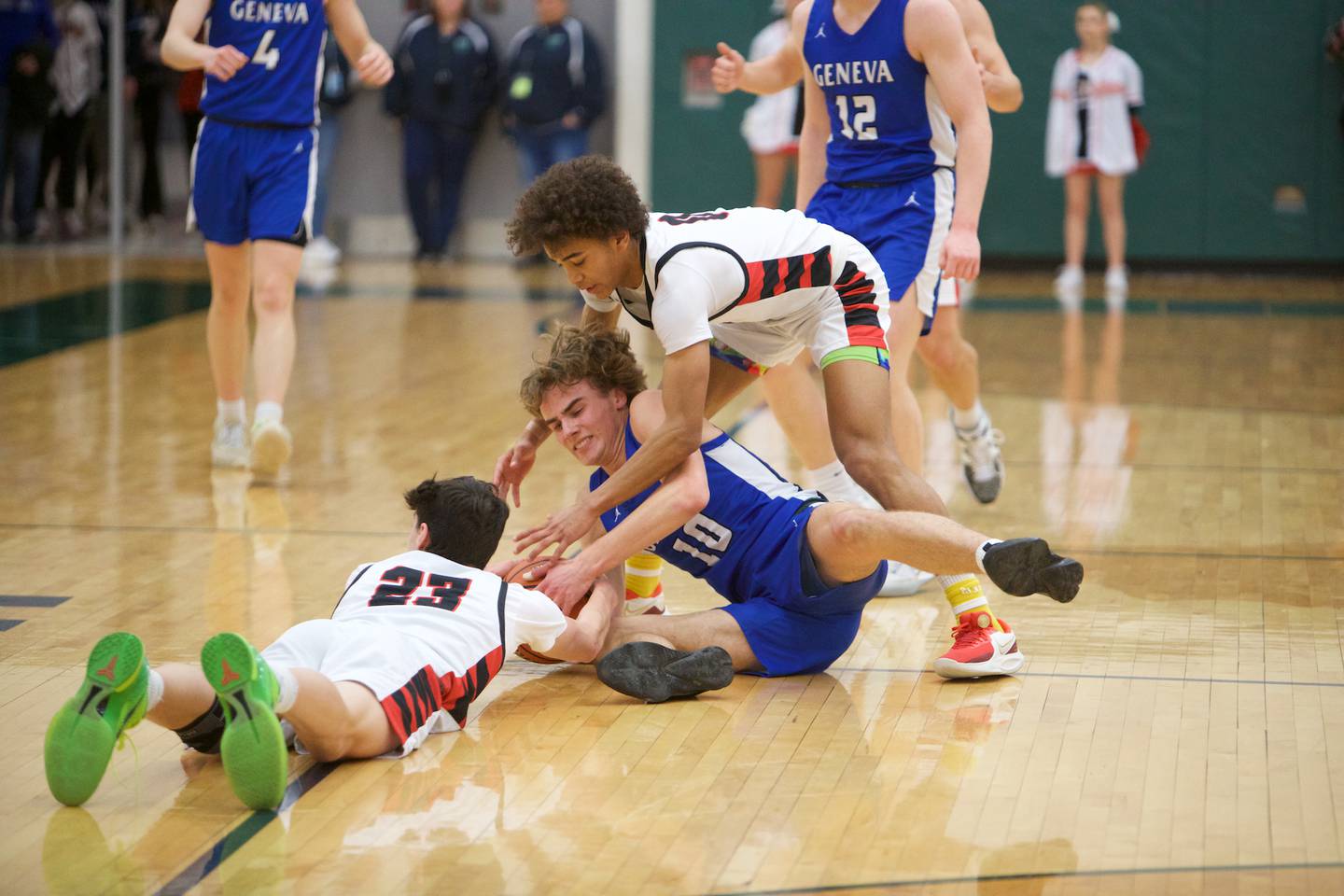 Geneva's Jack Hatto battles for the loose ball with Benet's Nikola Abusara (23) and Brayden Fagbemi (0) at the Class 4A Sectional Final at Bartlett on Friday, March 3, 2023.