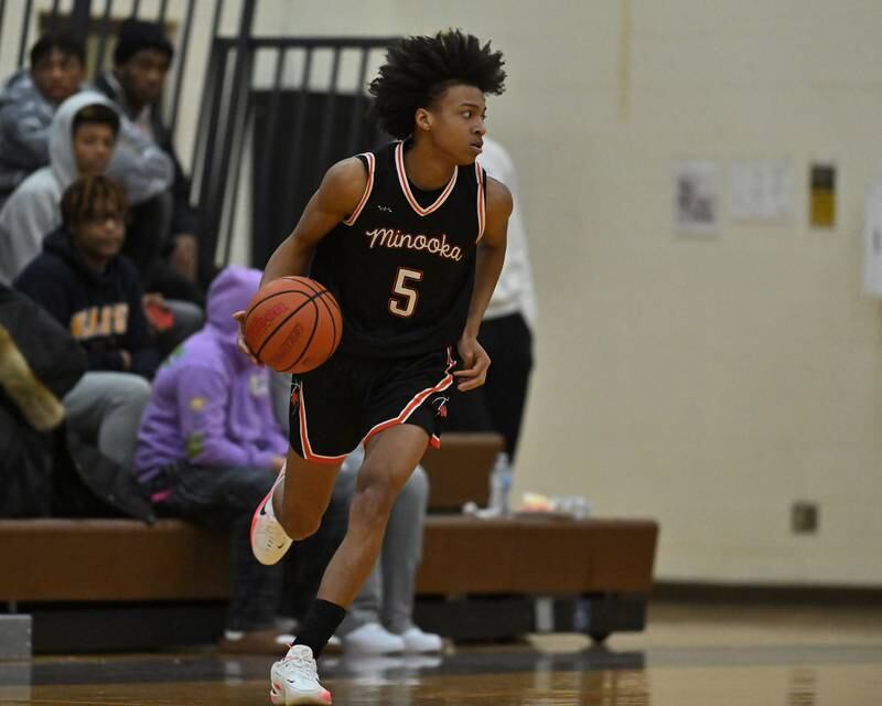 Minooka's Jahmai Mccoy (5) sets up the offense in the WJOL Basketball Tournament on Monday, November 21, 2022, at Joliet.