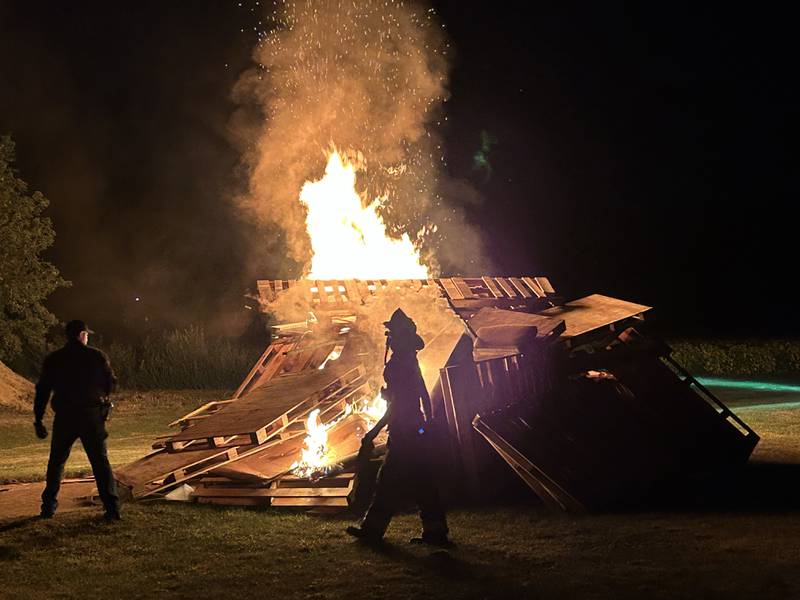 Oregon firefighters Dallas Stalkfleet and Greg Hunter start the homecoming bonfire in the field south of Oregon High School following the parade on Wednesday, Sept. 18, 2024. Homecoming festivities continue this week.
