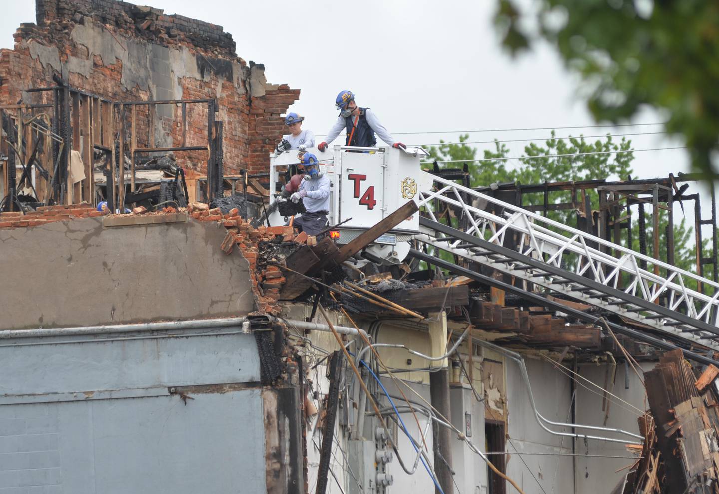 ATF investigators used a Sterling fire department ladder truck to gain access to the charred remains of an apartment building on Wednesday, July 12, 2023 as they continue to search for answers in the fatal July 7 fire at t 406 E. Third Street in Sterling.