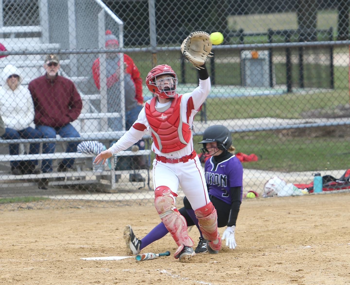 Oregon's Liz Mois reaches for a throw as Dixon's Morgan Leslie slides safely home during a Tuesday game at Oregon Park West.