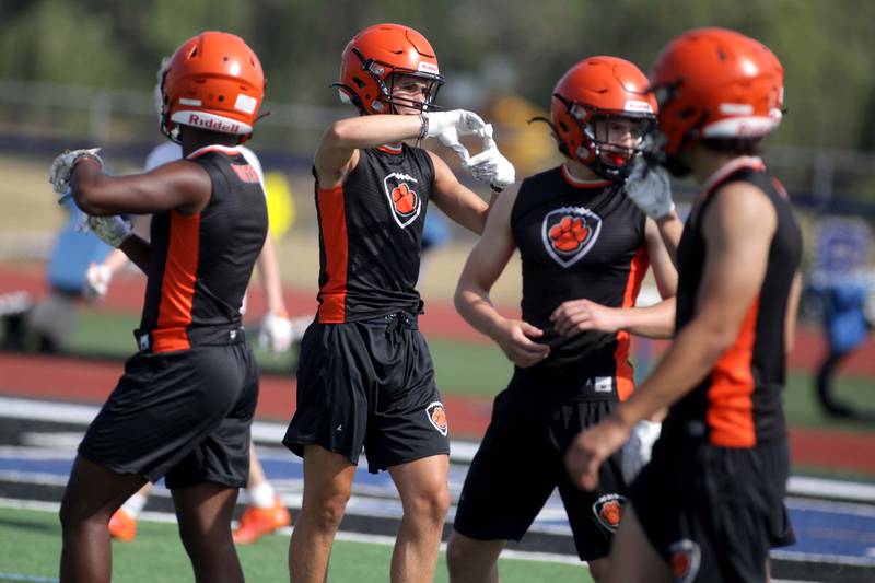 Wheaton Warrenville South players communicate with their coaches during a 7-on-7 football game against Hersey at St. Charles North on Thursday, June 22, 2023.