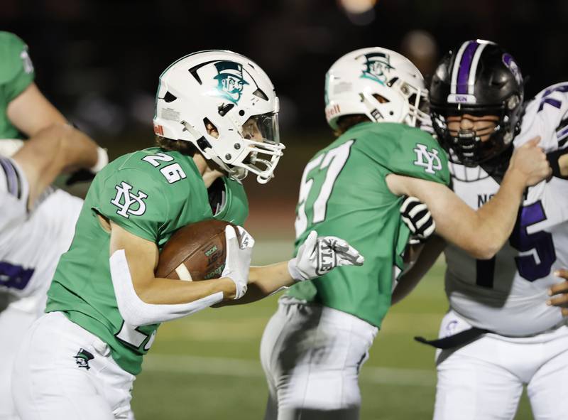 York's Henry Duda (26) runs with the ball during the varsity football game between Downers Grove North and York on Friday, Oct. 4, 2024 in Elmhurst.