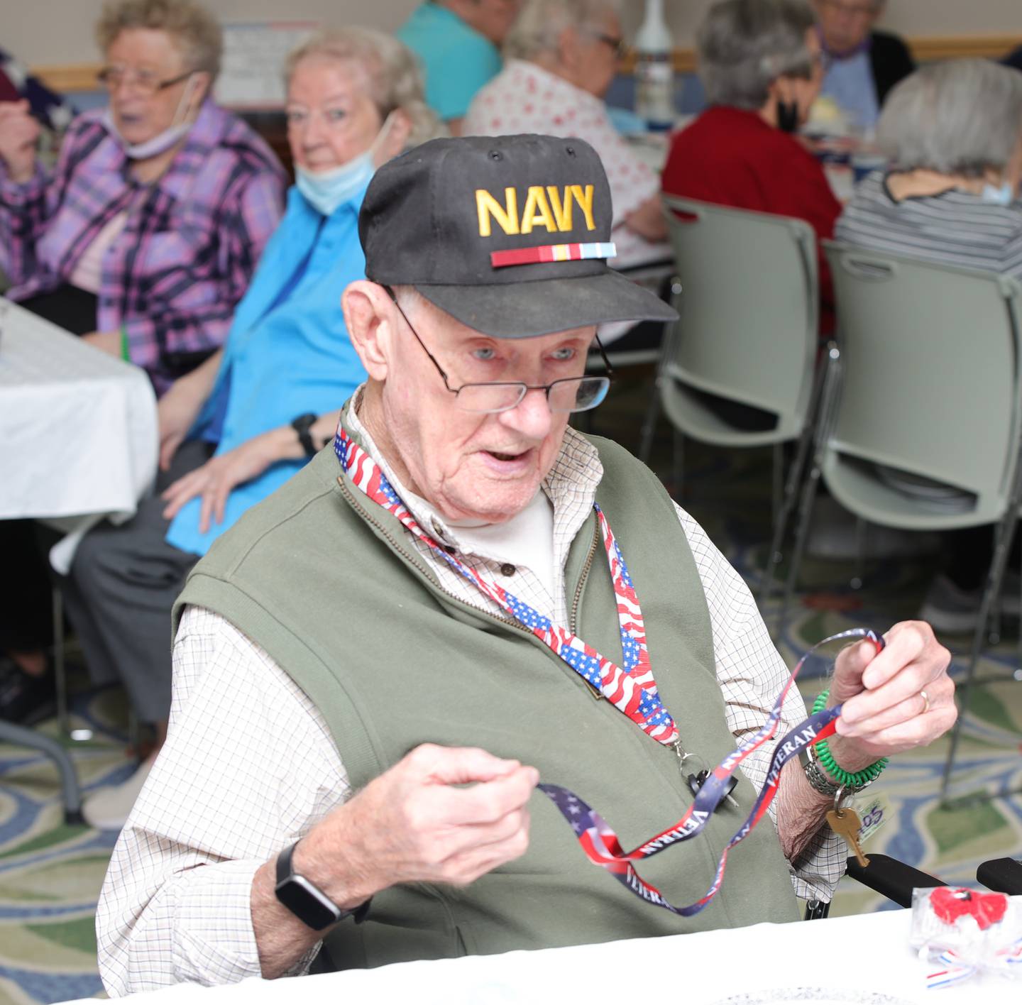 Timbers of Shorewood resident, John Dixon, a U.S. Navy Veteran, opens a goodie bag from the Timbers of Shorewood’s Veterans Day celebration on Friday, November 11, 2022.