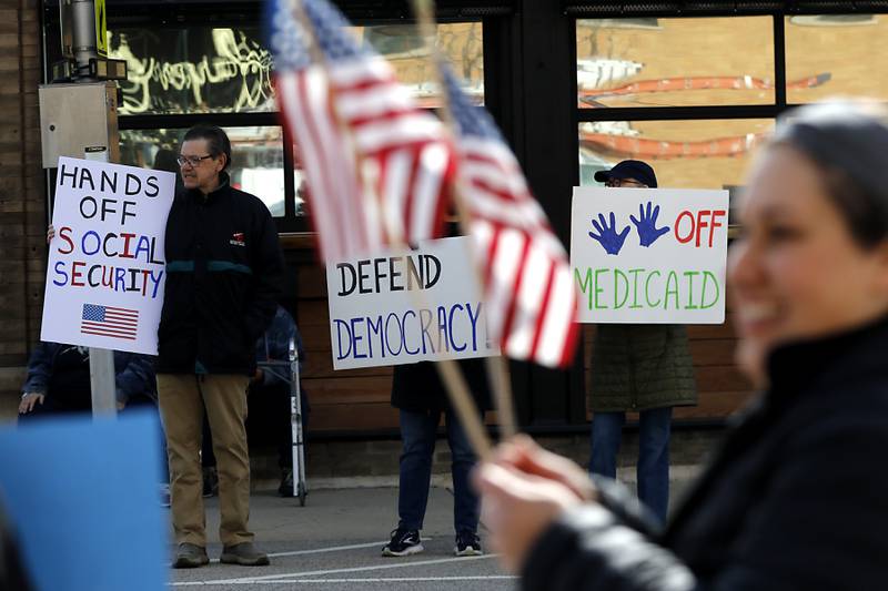 Protesters line U.S. Route 12 in Richmond to protest their discontent with President Donald Trump and his administration's policies on Saturday, April 19, 2025. Over 100, people took part in the Richmond protest. A second rally was held in Harvard later in the day.