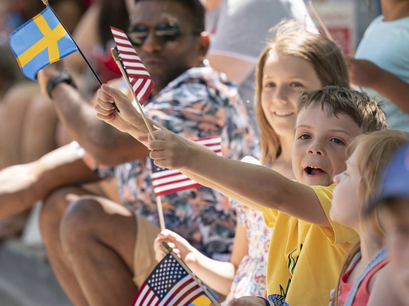 Shea Heimlich, 7, of St. Charles, waves a Swedish and American flag as he watches the annual Swedish Days Parade on S. 3rd Street in downtown Geneva on Sunday, June 26, 2022. The parade marked the last day of the festival which ran from June 22-26.