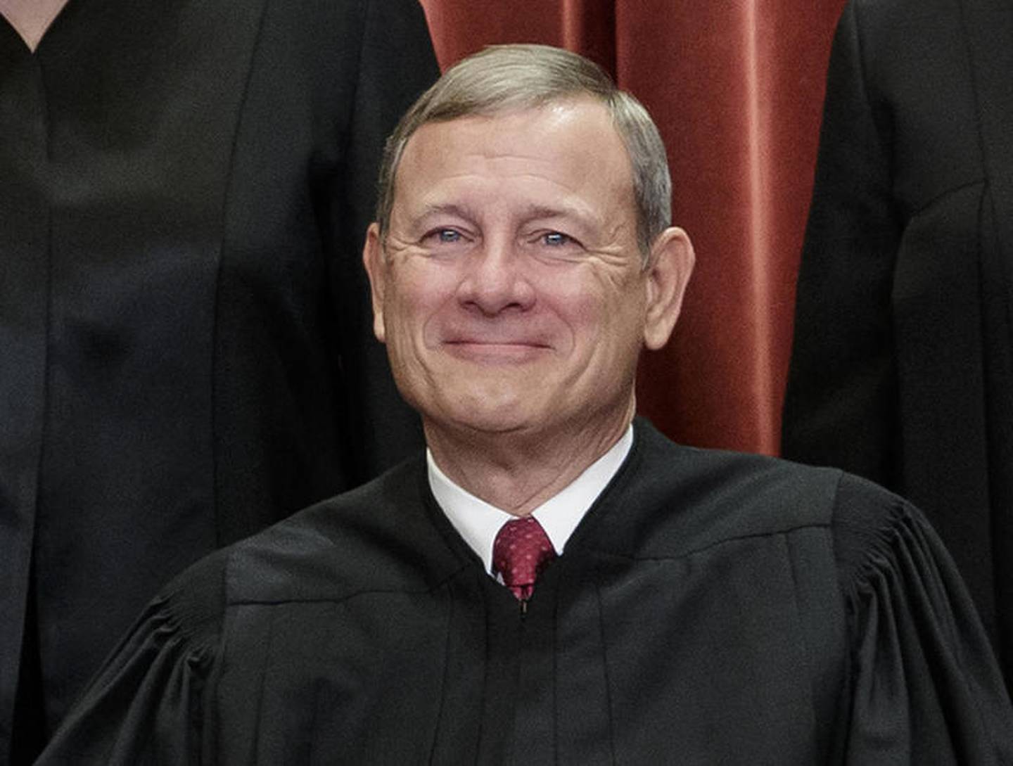 Chief Justice of the United States, John Roberts, sits with fellow Supreme Court justices for a group portrait Nov. 30 at the Supreme Court Building in Washington. Just hours after Chief Justice John Roberts handed Republicans a huge victory that protects even the most extreme partisan electoral districts from federal court challenge, critics blasted him as worthy of being impeached, a politician who should run for office and a traitor.