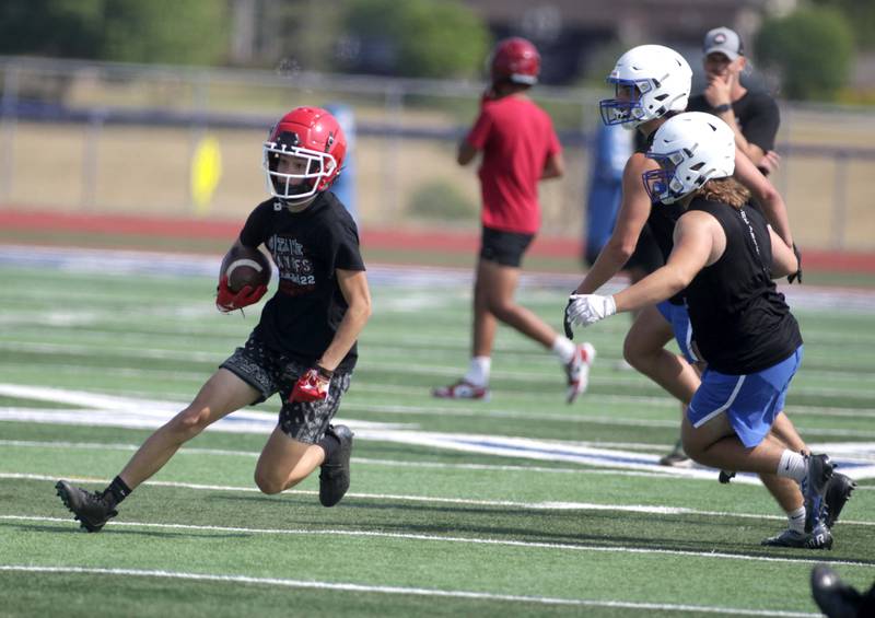 A Yorkville player runs the ball during a 7-on-7 football game against St. Charles North at St. Charles North on Thursday, June 22, 2023.