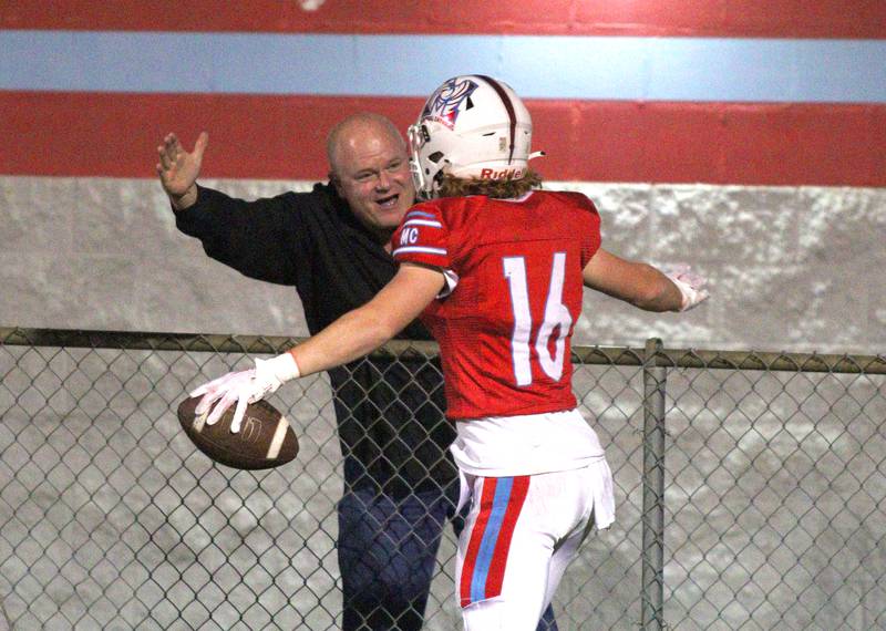 Marian Central’s Jacob Sievert is greeted in the end zone after hauling in a touchdown reception against Chicago Hope in varsity football at Woodstock Friday night.
