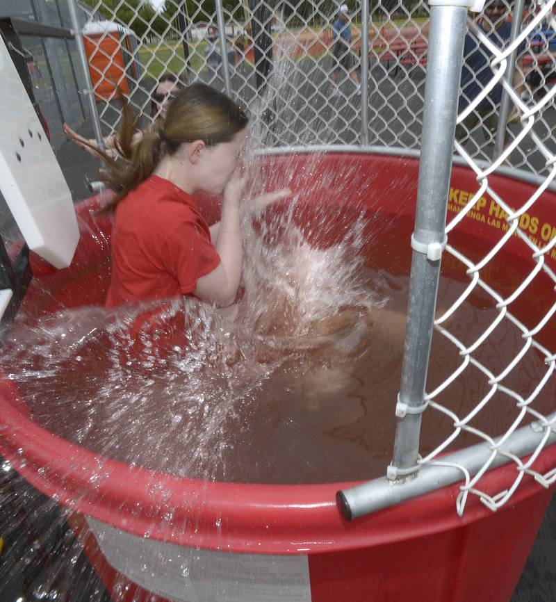 Addison Sherman gets cooled off as she lands in the dunk tank as part of a fundraiser for the Hall Devilettes Saturday during Spring Valley’s Summerfest.