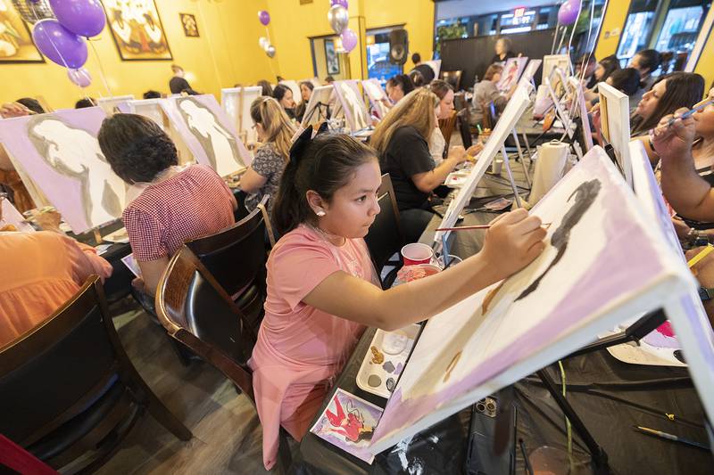 Esmeralda Flores, 9, of Sterling focuses on the details of her Selena painting Monday, April 15, 2024 in Sterling.