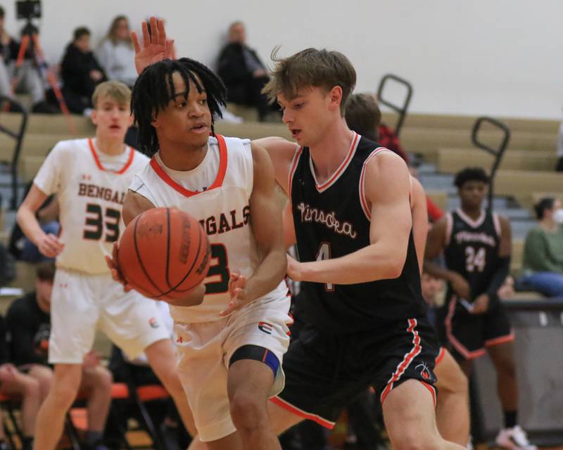 Plainfield East's James Jones (3) passes underneath the basket during a 50-26 win over Minooka on Friday, Jan. 13, 2023.