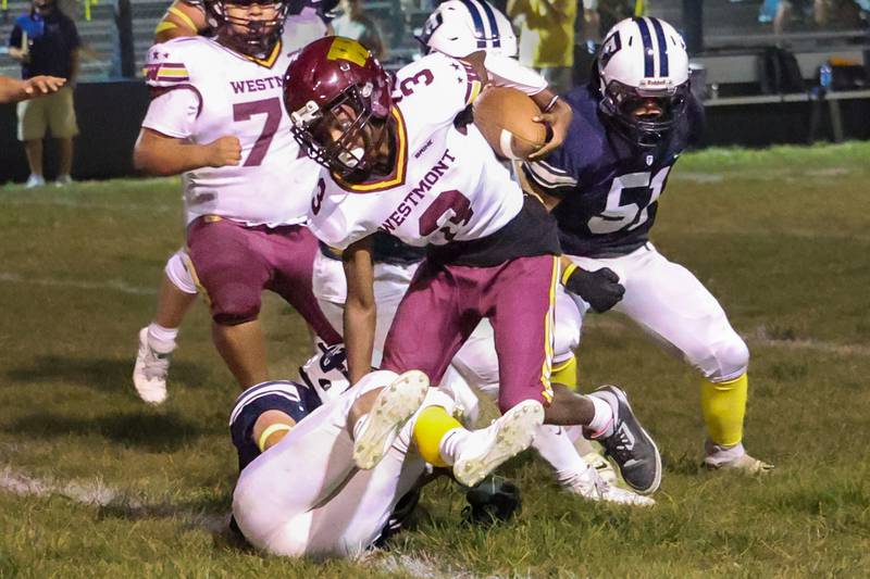 Konor Rogers of Westmont runs ball whilst being tackled by Fieldcrest player on Friday, September 20, 2024 at Fieldcrest high school in Minonk.