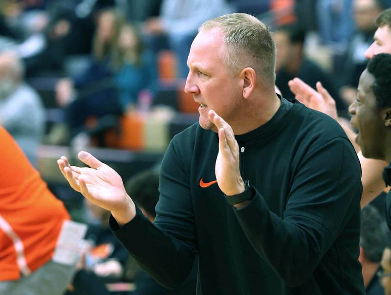 DeKalb basketball head coach Mike Reynolds urges on his team during their game against Naperville North Friday, Dec. 8, 2023, at DeKalb High School.