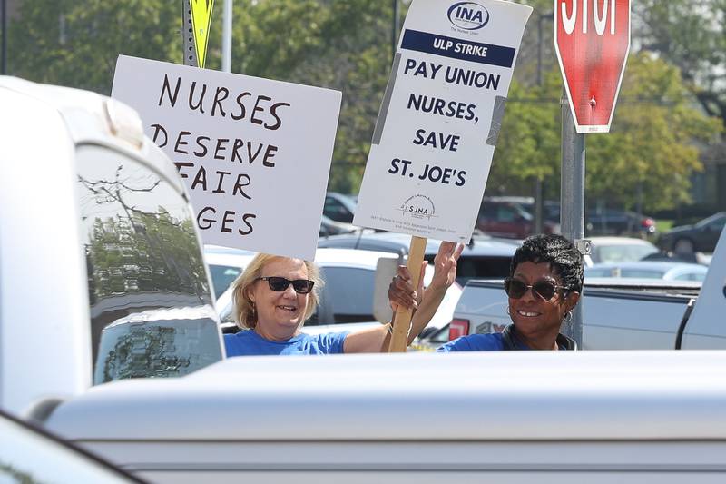 Several picketers wave to cars as they honk in support of the nurses strike outside Ascension Saint Joseph-Joliet hospital on Thursday, Aug. 24, 2023.