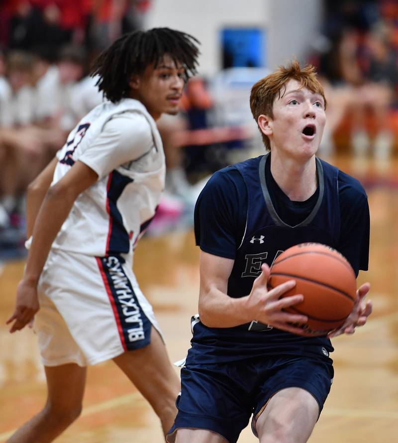 Oswego East's Noah Mason (right) drives to the basket during a Hoops for Healing tournament game against West Aurora on Nov. 20, 2023 at Naperville North High School in Naperville.