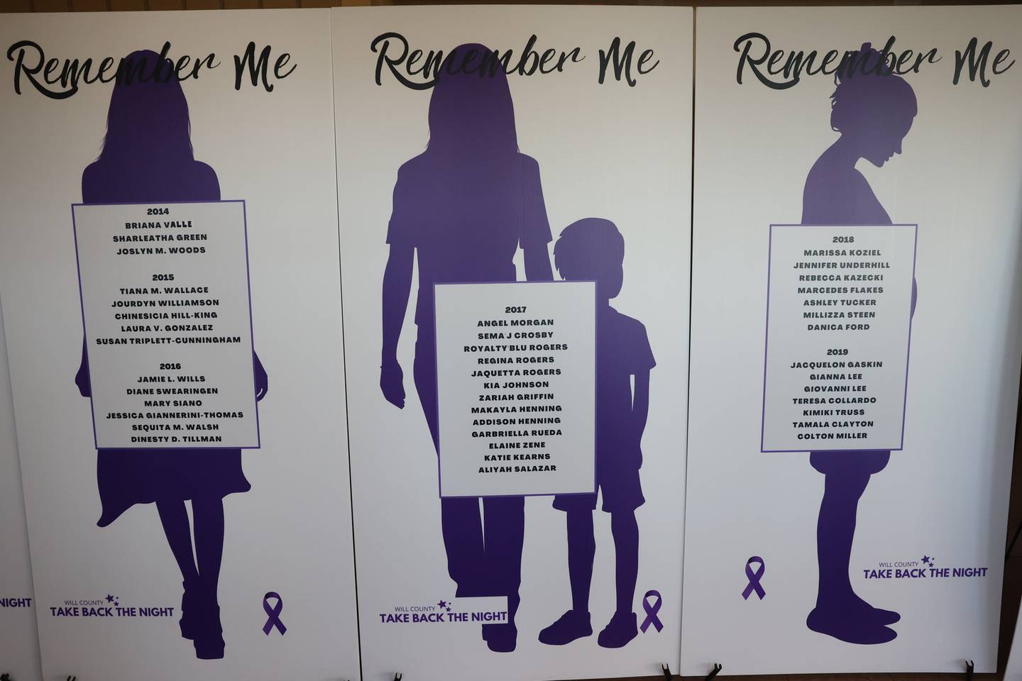 Posters with the names of women that lost their lives due to domestic violence in Will County is displayed at the entrance of the Take Back the Night event at Hufford Junior High on Thursday, Oct. 5, 2023 in Joliet.