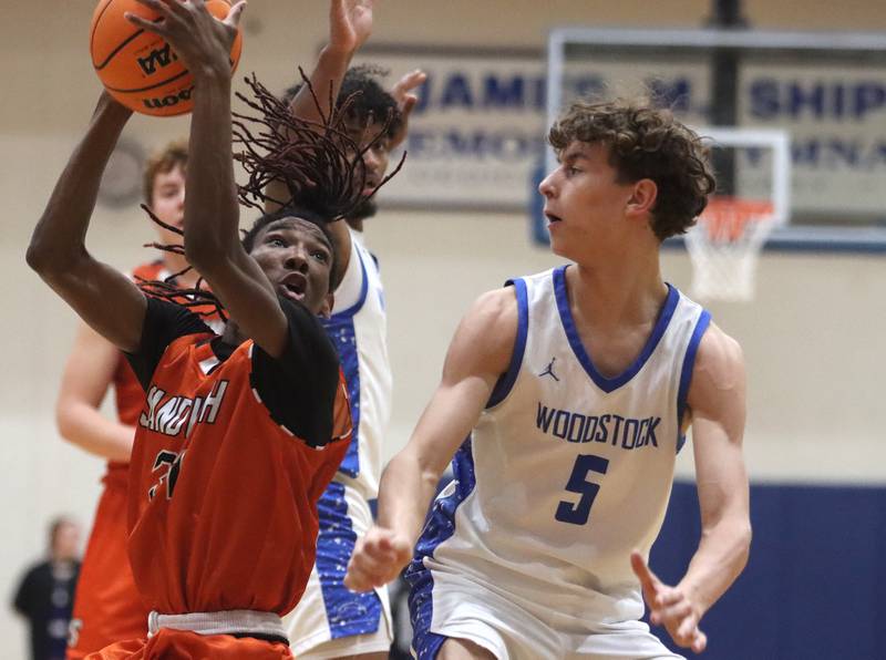 Woodstock’s  Max Beard, right, guards Sandwich’s EJ Trwptow in varsity boys basketball on Tuesday, Feb. 11, 2025, at  Woodstock High School in Woodstock.