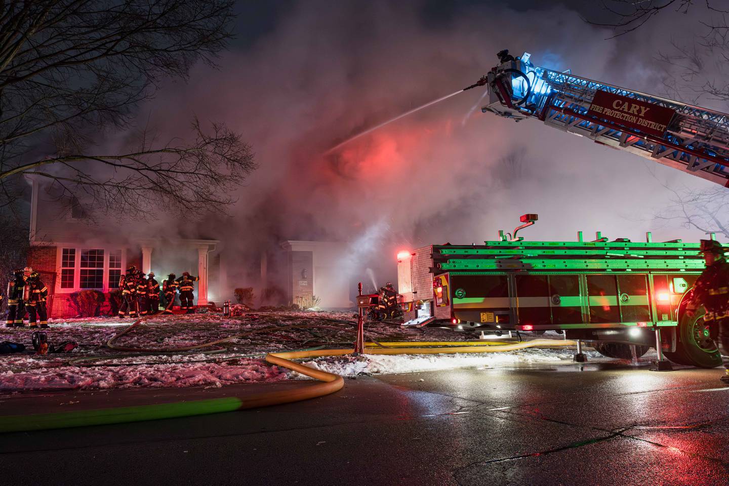 Crews battle a large fire that engulfed a Cary home on Dec. 31, 2025. A dog was missing after the blaze.