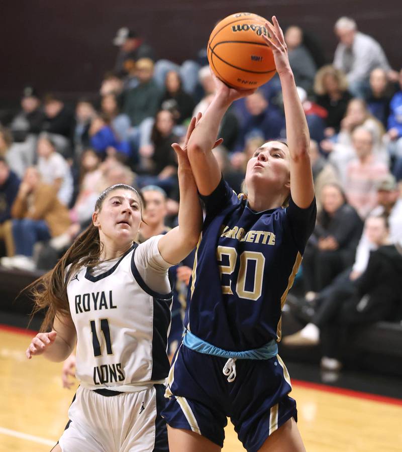 Marquette's Kaitlyn Davis is fouled by Rockford Christian's Lucy Gargani Tuesday, Feb 24, 2026, during their Class 1A sectional semifinal game at Indian Creek High School in Shabbona.
