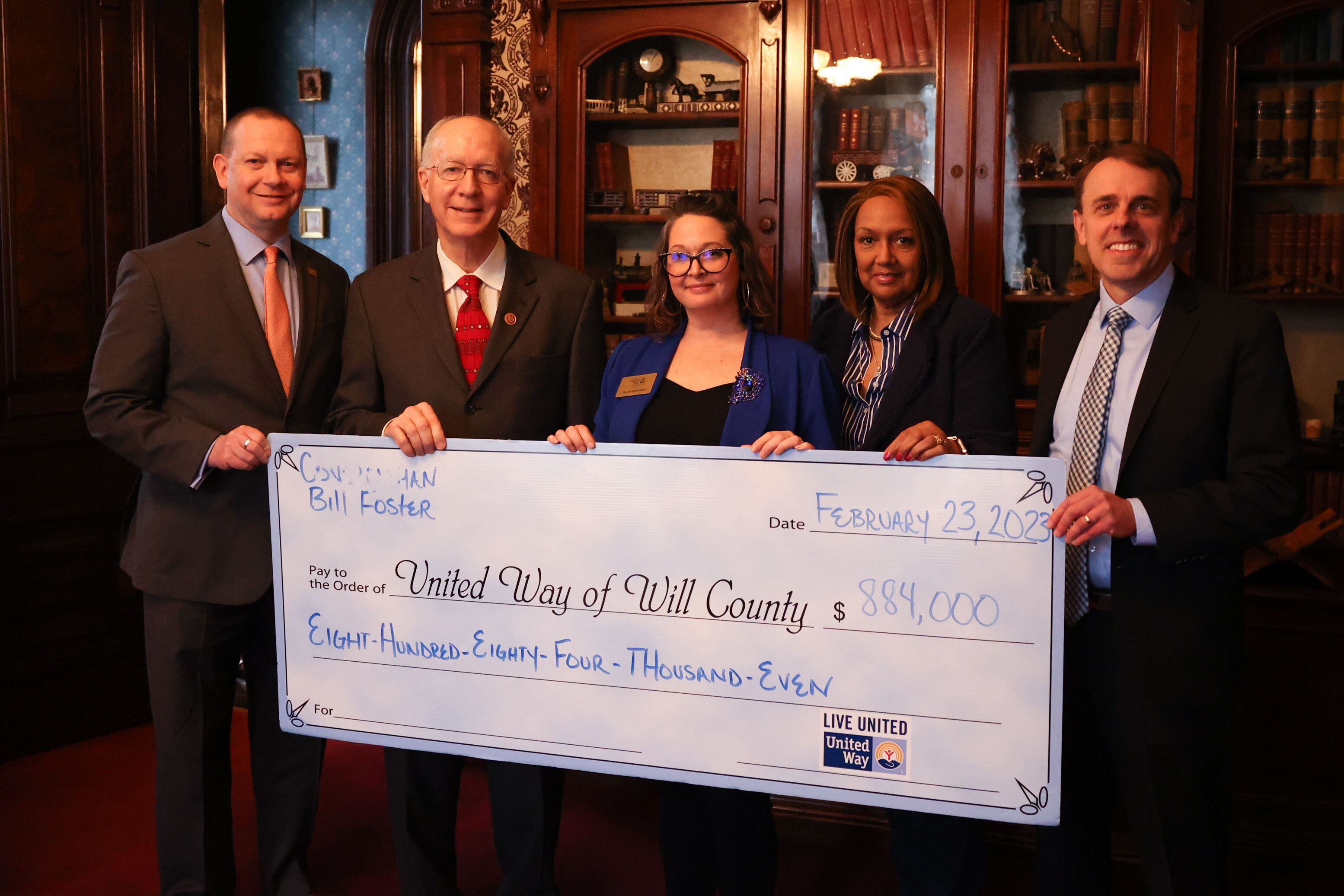 Billy Hearth, United Way Chair of Board, Congressman Bill Foster (D-Ill), Sarah Oprzedek, United Way of Will County CEO, Leslie Rienzie, Director of HR Willy County Circuit Court, and Tom Klisiewicz, founder and President of Smart HP, pose with a $884k check for United Way of Will County at a United Way private event at the Jacob Henry Mansion on Thursday, February 23rd, 2023 in Joliet.