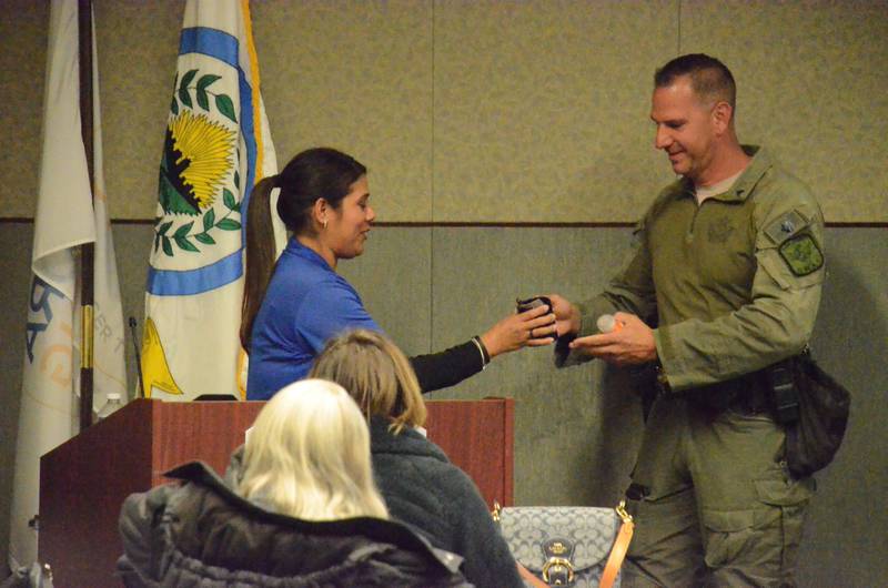 Citizens Police Academy of Aurora Alumni president Veronica Carter, left, greets Kane County Sheriff's Sgt. Nicholas Wolf, K-9 Academy supervisor, Tuesday, Nov. 14. (Al Benson photo)