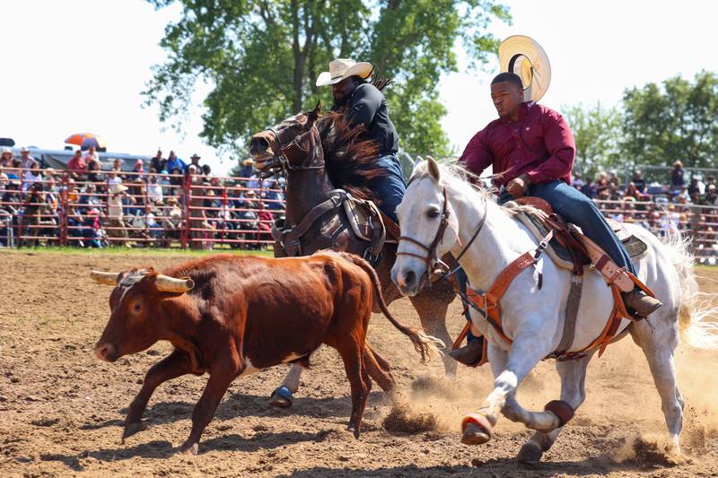 Robert Hughes, left, and his nephew Max Clark, both of Crete, compete during the 50th Pembroke Rodeo on Sunday, May 24, 2026.