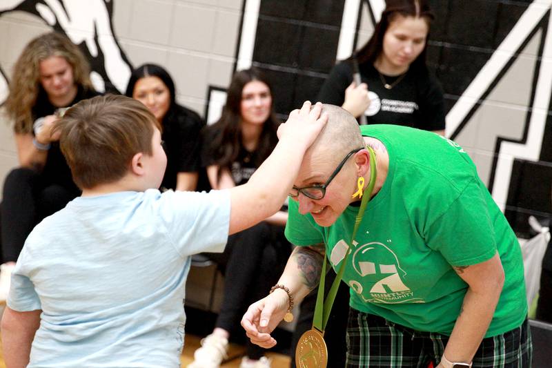 Harrison Shaw, 9, touches his teacher, Jennifer Slad’s, head after it was shaved at Marlowe Middle School in Huntley for a St. Baldrick’s Foundation fundraiser. Slad is a special education teacher at Martin Elementary School in Huntley.