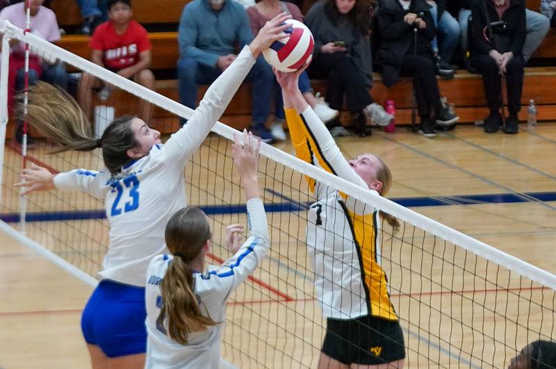 St. Charles North's Haley Burgdorf (23) plays the ball above the net against Metea Valley's Katie Schuele (7) during a Class 4A West Aurora Sectional semifinal volleyball match at West Aurora High School on Tuesday, Nov. 5, 2024.