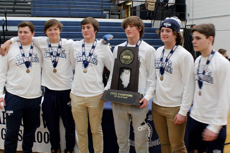 Cary-Grove football team members (from lert:) Taylor Anderson, Liam Waco, Michael Gustafassan, Ryan Gustafassan, Nick Wojcik, and Jake Lukasik pose for a photo with the state championship trophy during a celebration of the 2021 Class 6A state championship football team at Cary-Grove High School on Sunday, Nov. 28, 2021 in Cary.