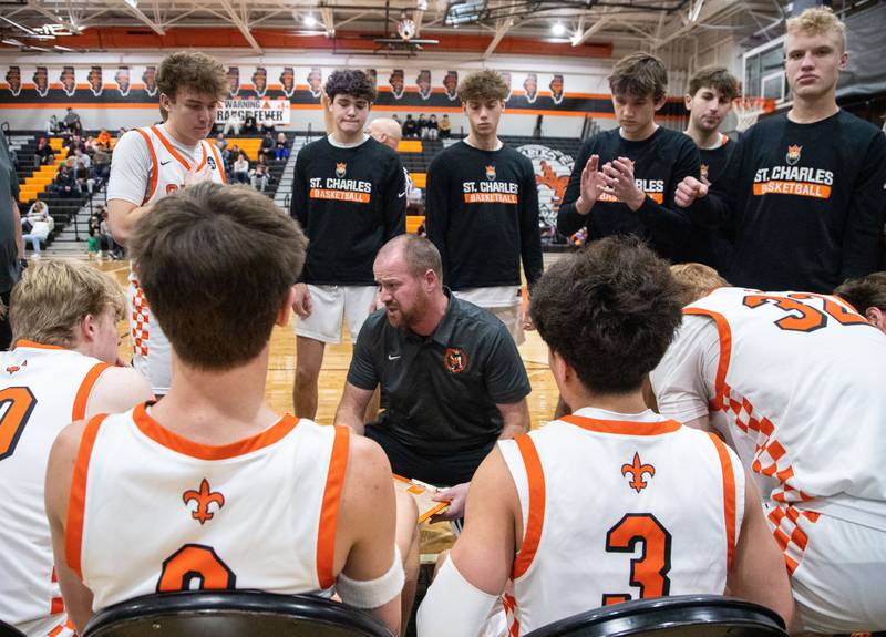 St. Charles East head coach Rob Klemm makes a plan for the second quarter during a game against Marmion Academy on Saturday, Jan. 4, 2025.