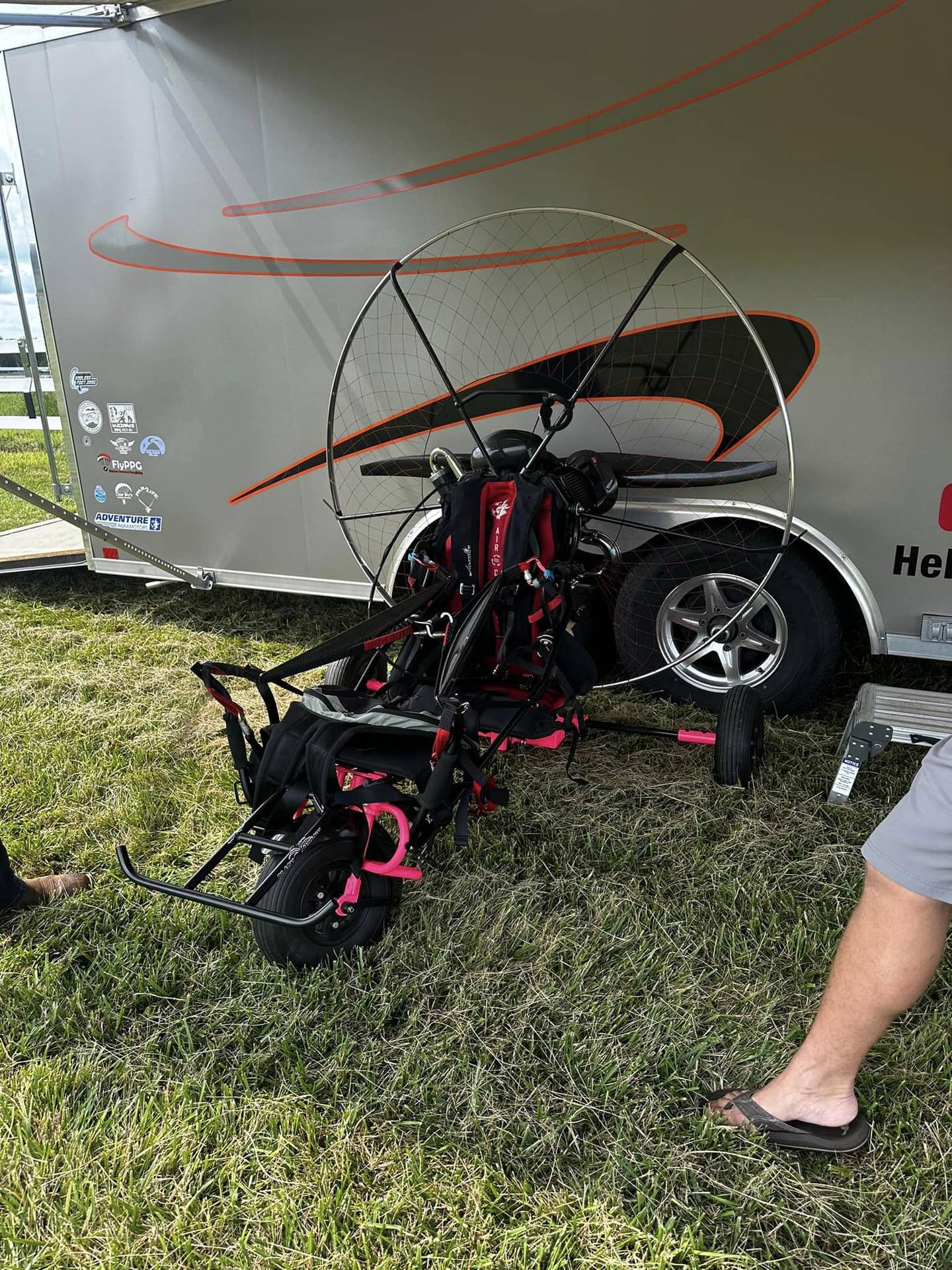 A powered paraglider setup: a lightweight wing and motor unit that allows for takeoff, flight and landing.